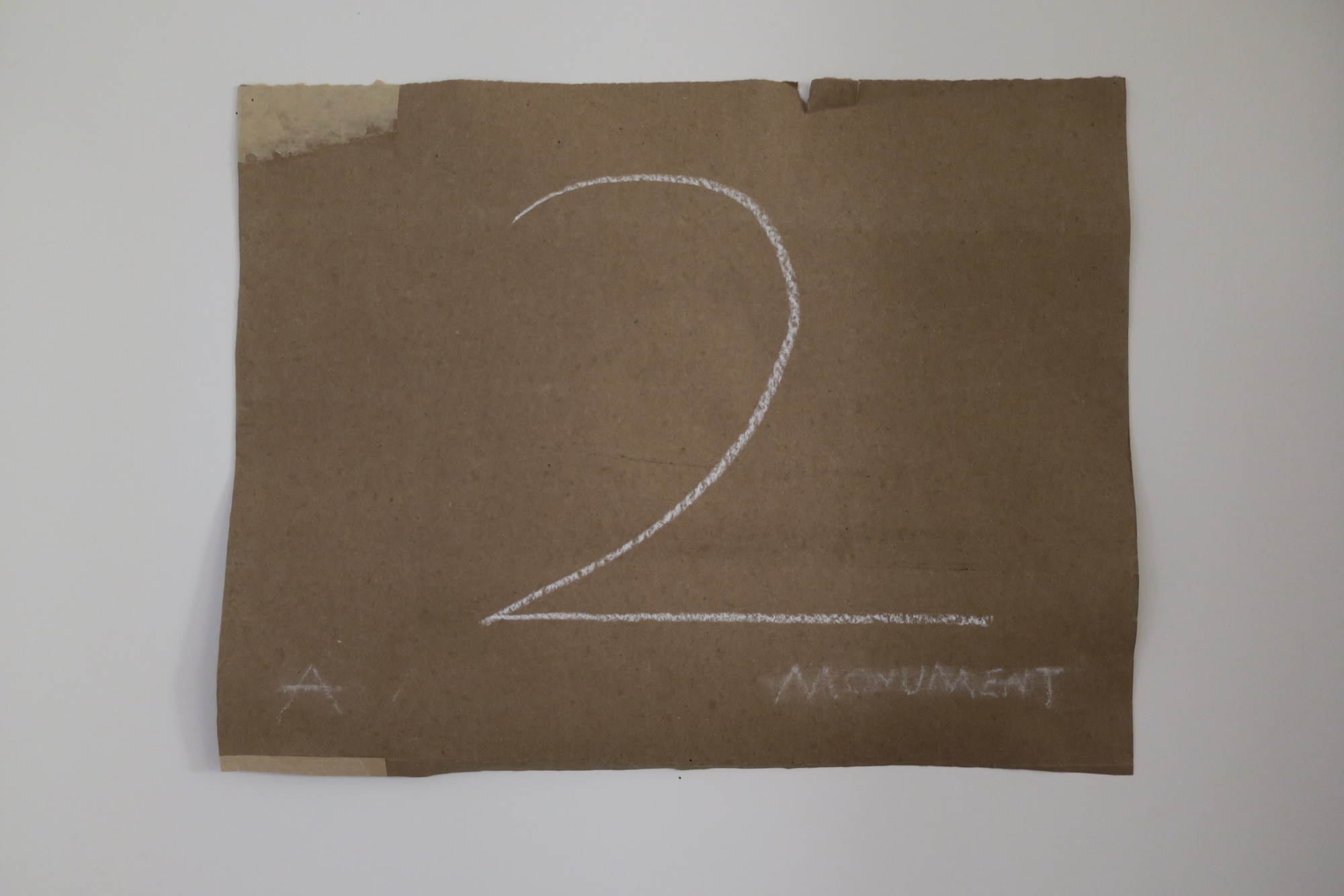 2: A Monument, 2023 — title card, chalk lettering on cardboard