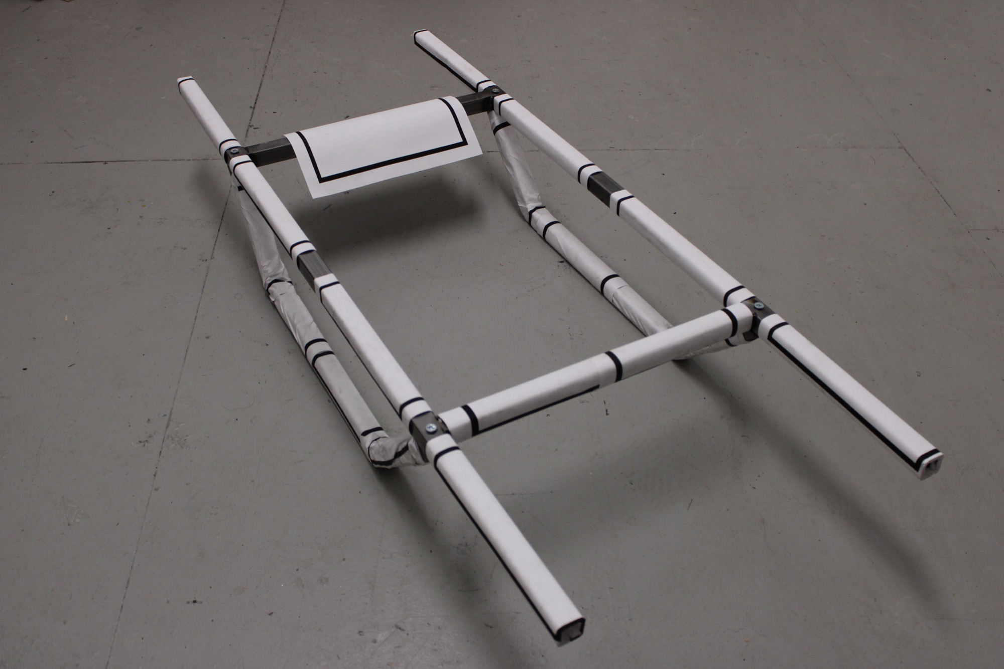Confinement, 2026 — overhead view of the object on the floor
