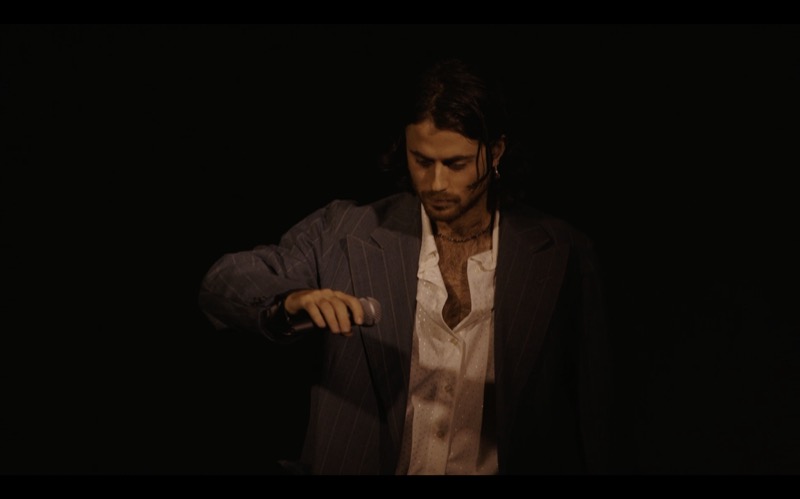 What We Don't Hear, 2023 — performance still, performer with hidden ring controller